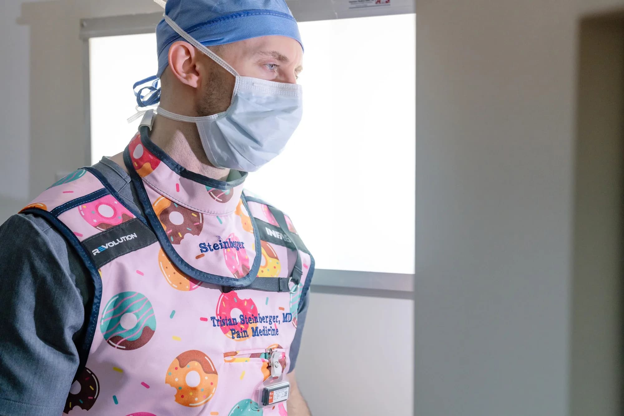 Dr. Steinberger in a lead apron and radiation dosimeter badge before an image-guided procedure